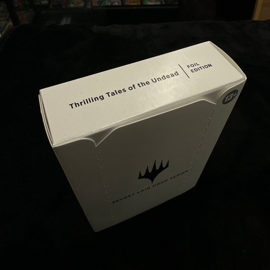 Card game box with text and mtg logo on a dark surface