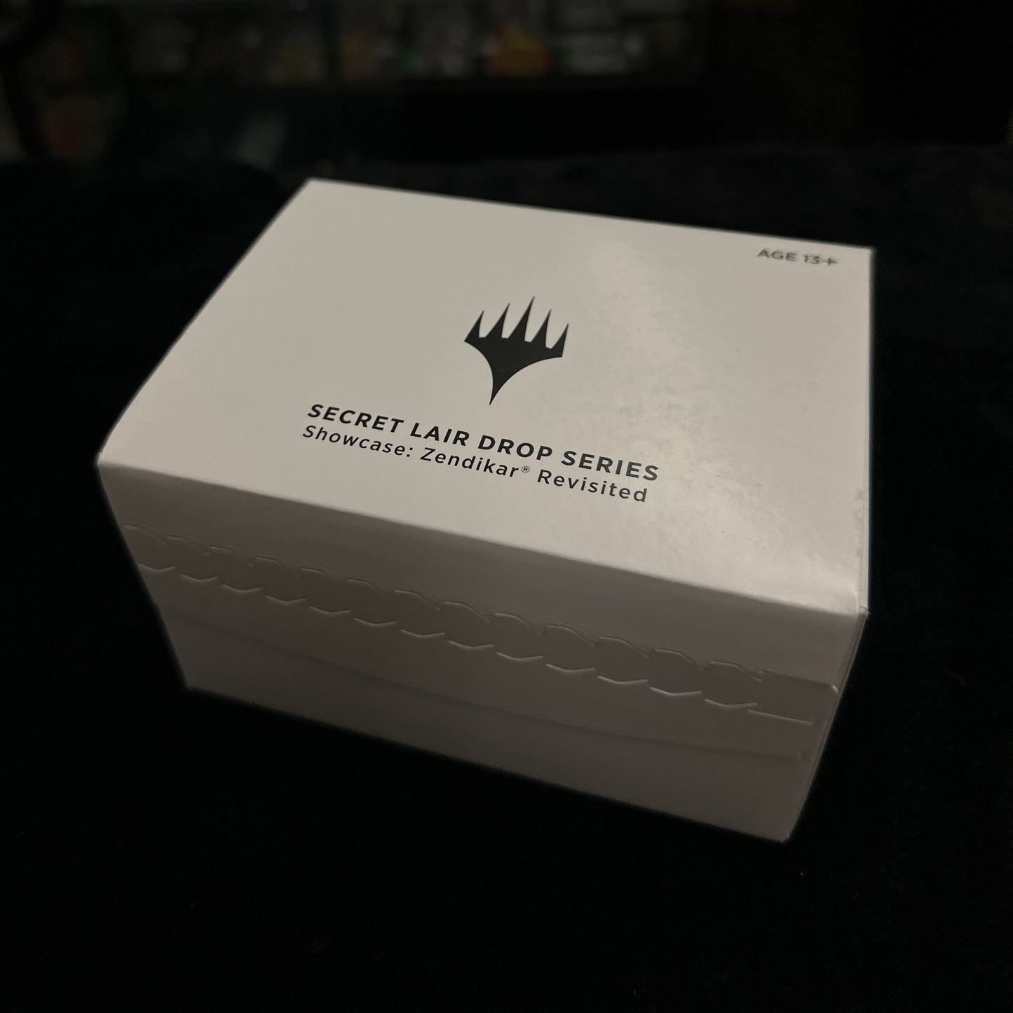 White box with black text and logo on a dark background