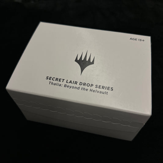 White box with black text and mtg logo on a dark background