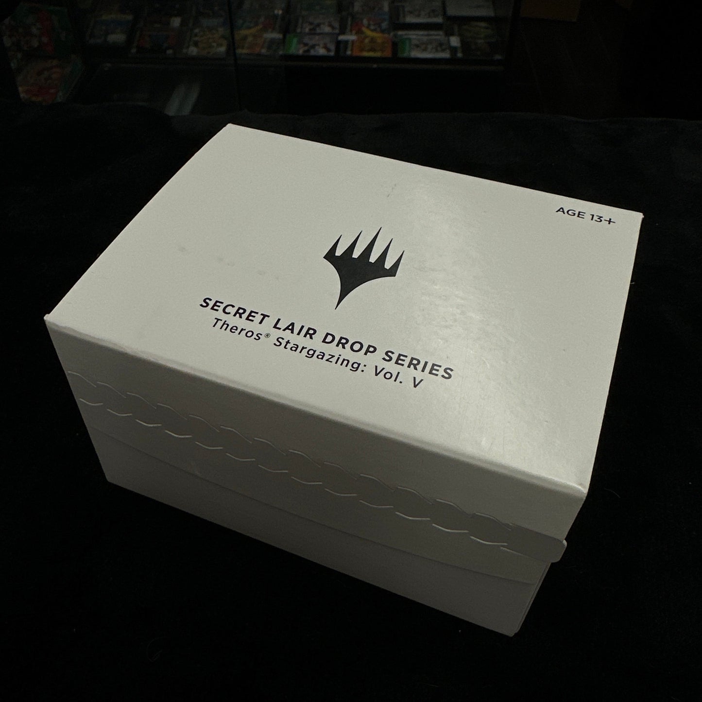 White box with black text and logo on a dark background