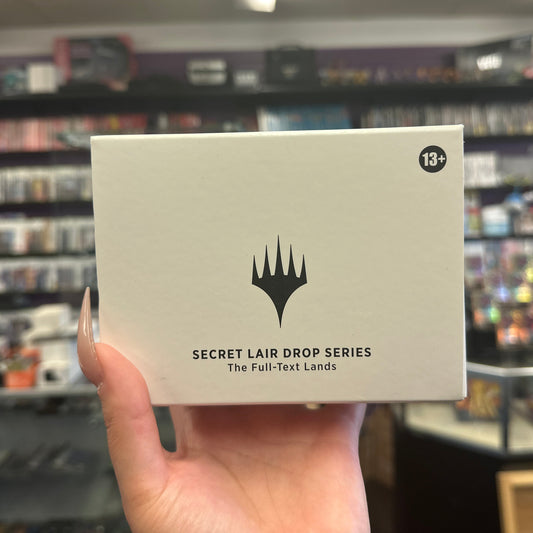 Hand holding a card game box with 'Secret Lair Drop Series' text in a store setting