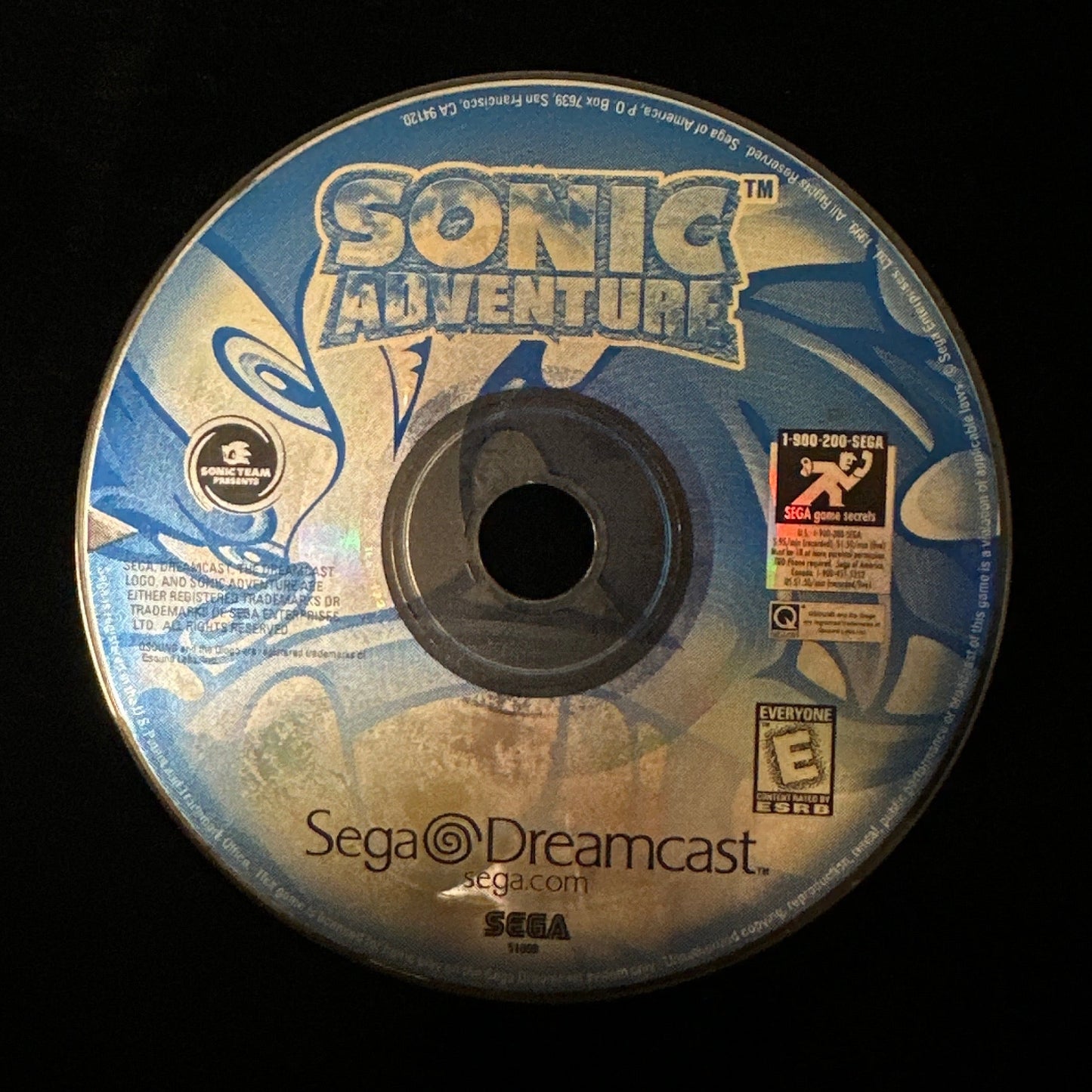 A Sonic Adventure Sega Dreamcast game disc on a black background.