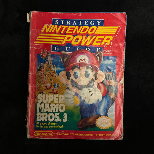 Super Mario Bros. 3 game box on a black surface