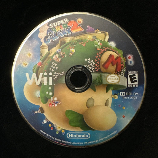 A Super Galaxy 2 video game disc for the Nintendo Wii, featuring Mario and other characters on the cover art, resting on a black surface.