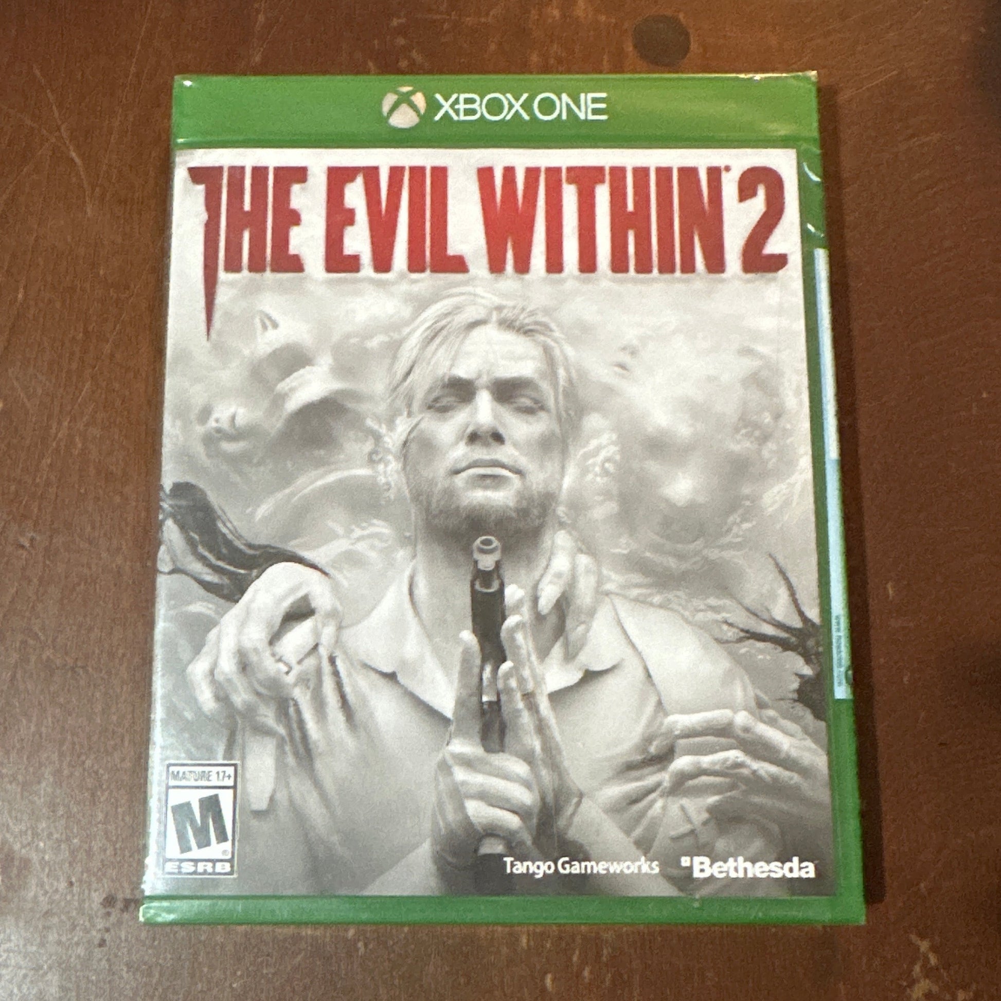 Game case for 'The Evil Within 2’ on a wooden surface
