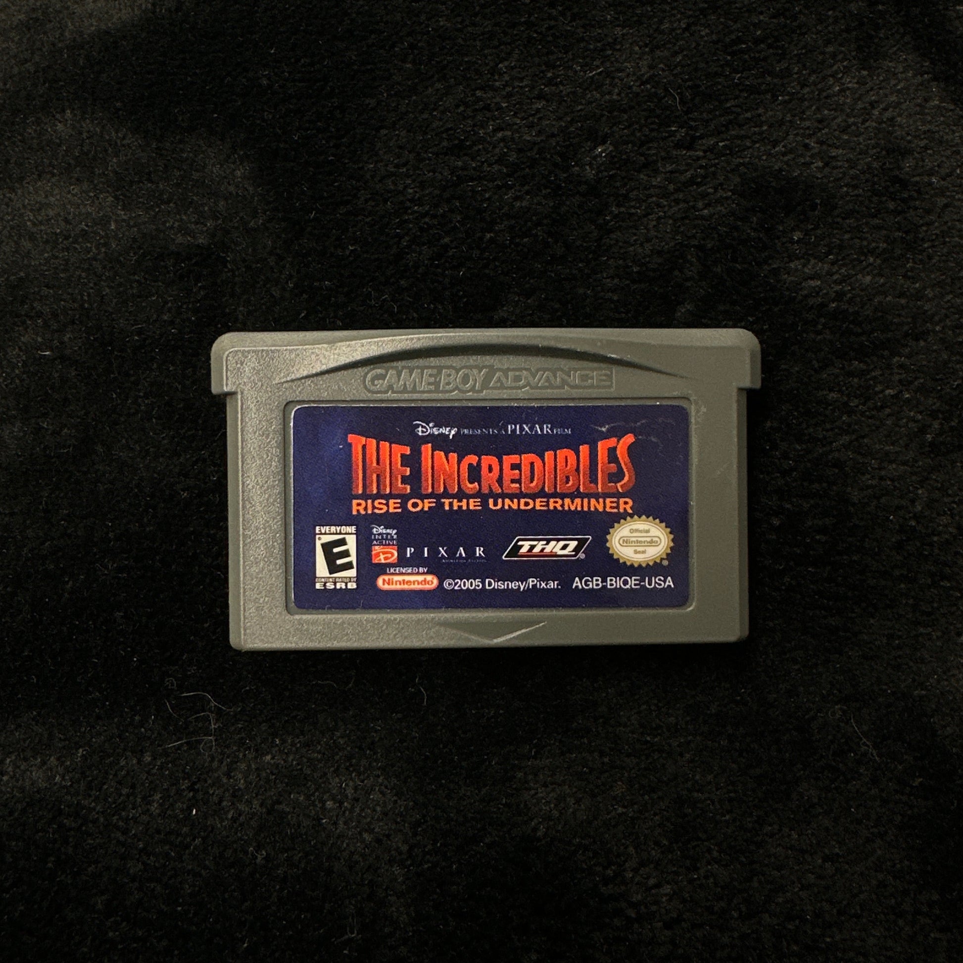 Game cartridge for 'The Incredibles' on a black background