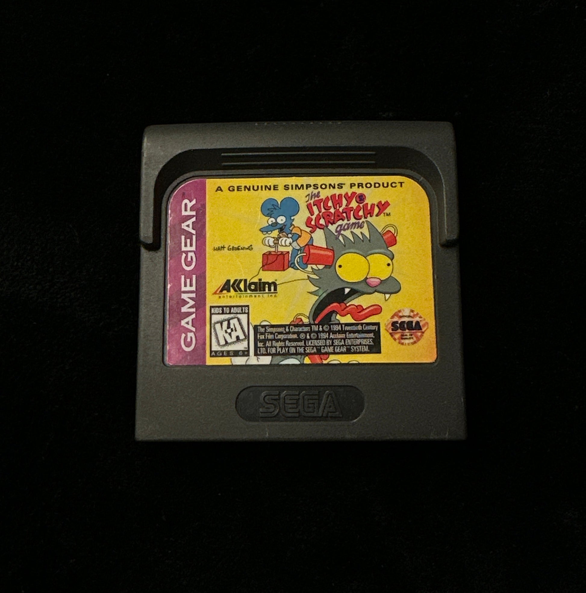 Vintage Game Gear cartridge with colorful design on a black background