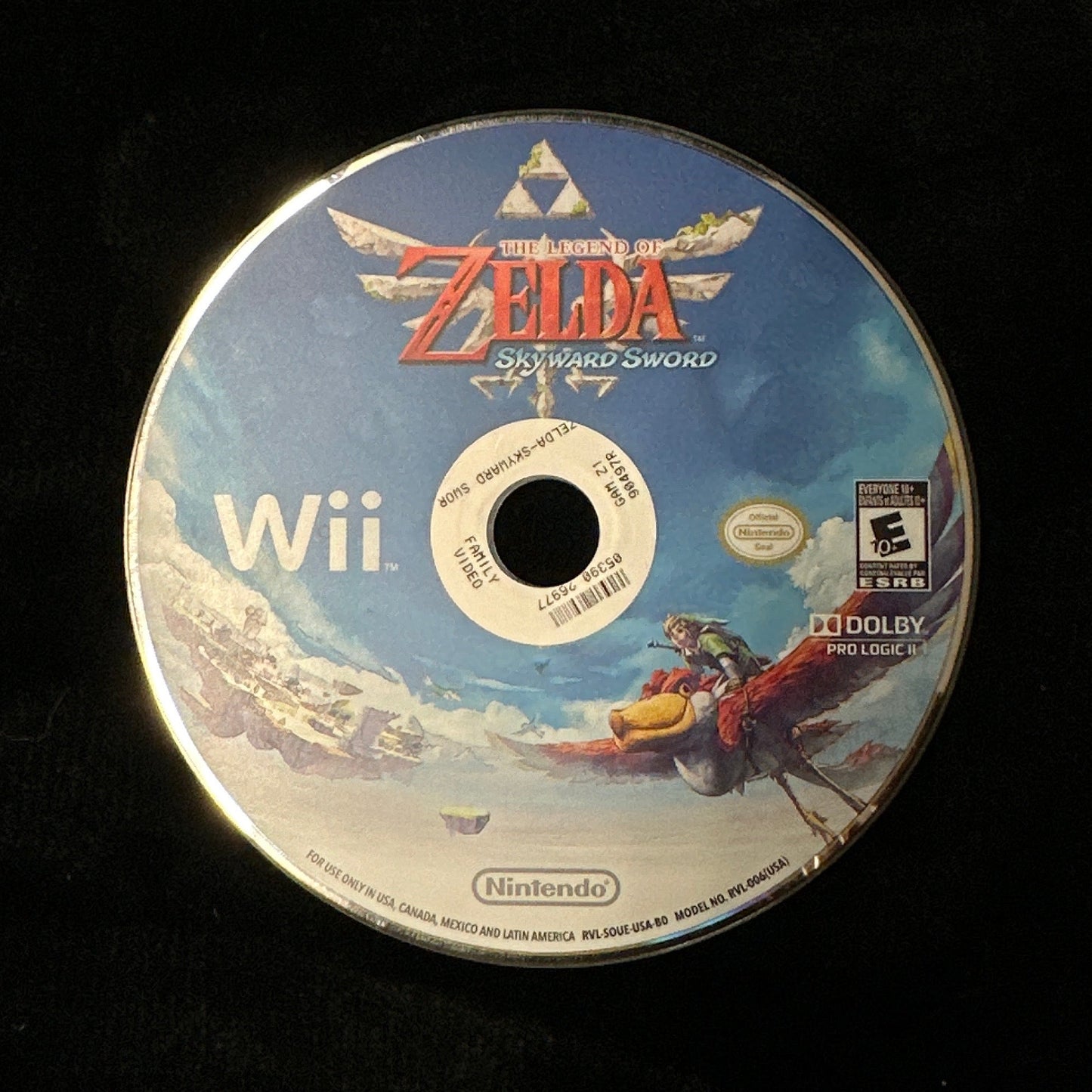 A Nintendo Wii game disc for The Legend of Zelda: Skyward resting on a black fabric surface.