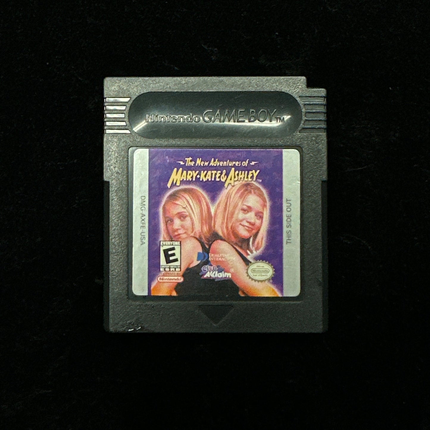 Game cartridge with a label featuring two people on a black background