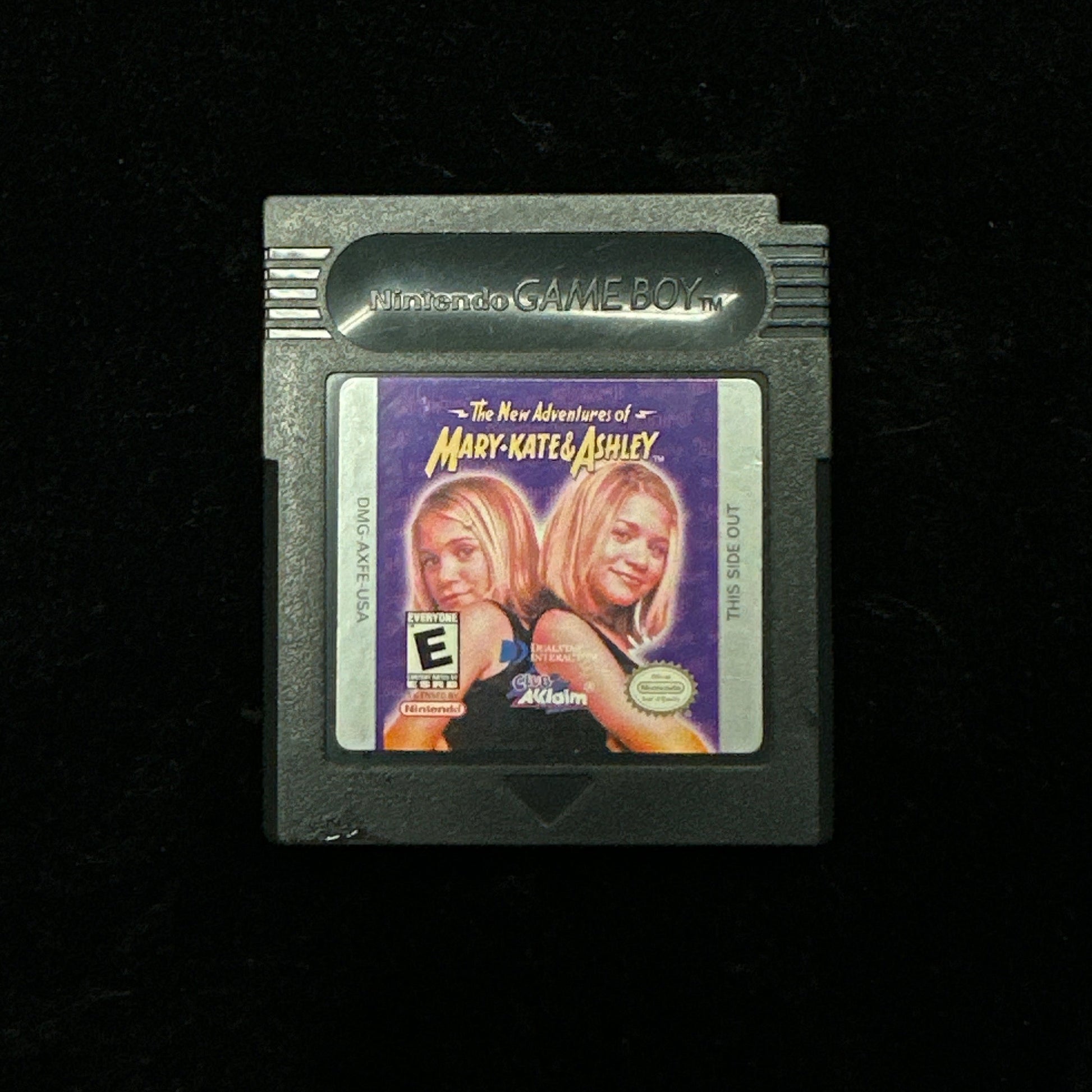 Game cartridge with a label featuring two people on a black background