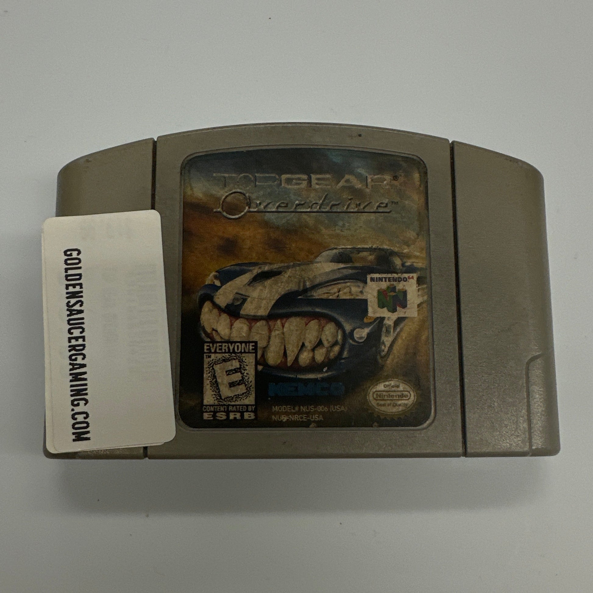 Vintage gaming console with a label on a white background