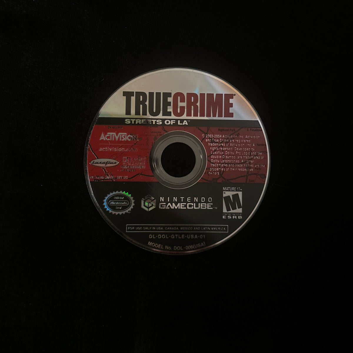 A single True Crime: Streets of LA video game disc centered on a black background.
