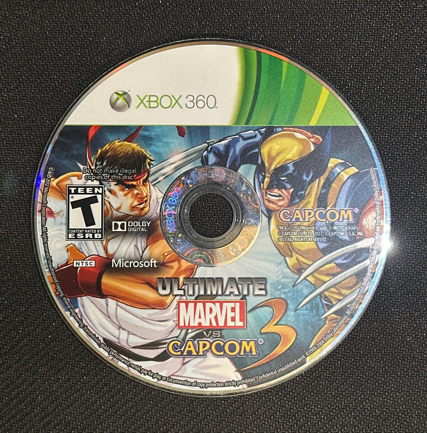 Game disc for 'Ultimate Marvel vs. Capcom 2' on a black background