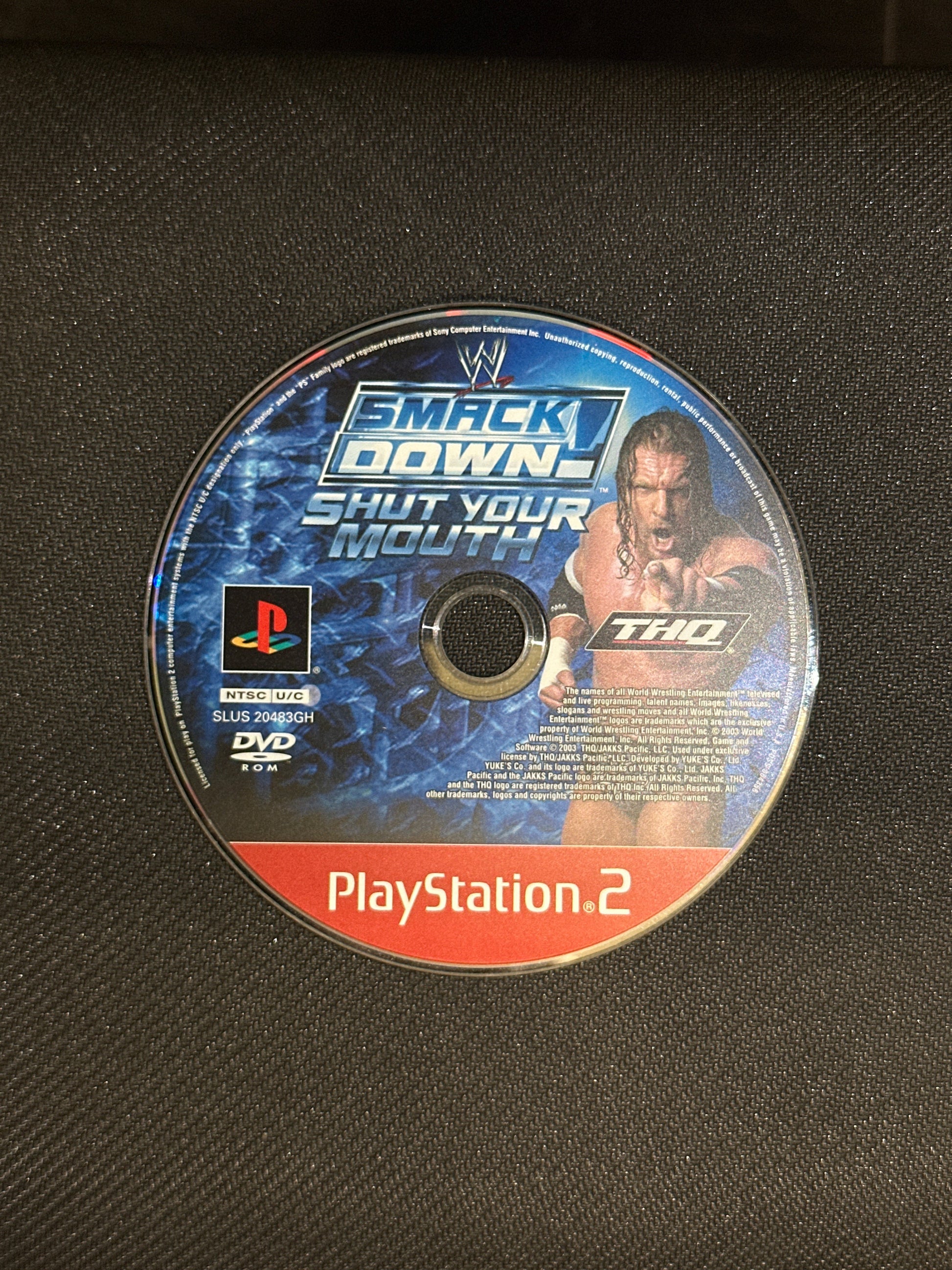 PlayStation 2 game disc with branding on a black background