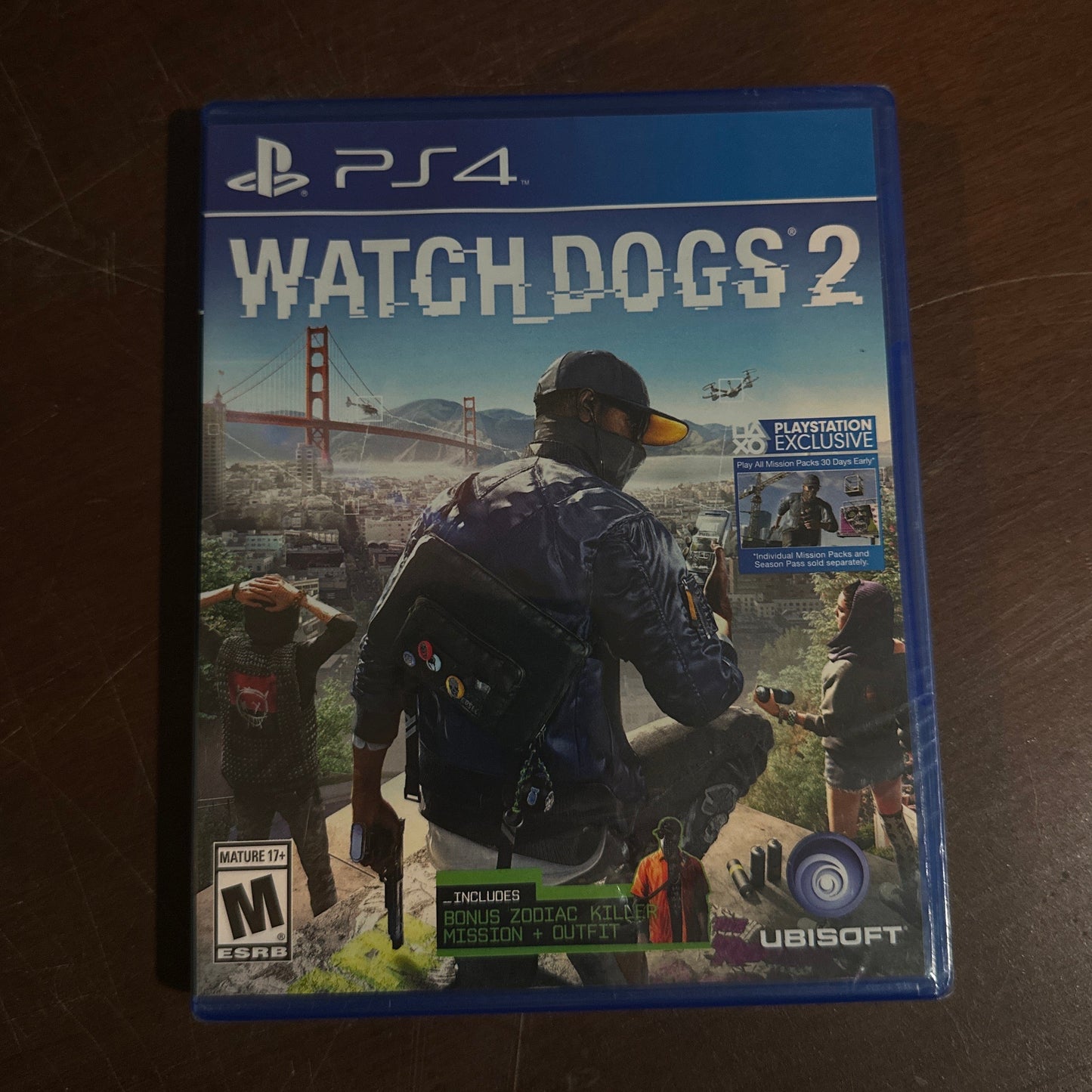 Watch Dogs 2 game case for PS4 on a wooden surface