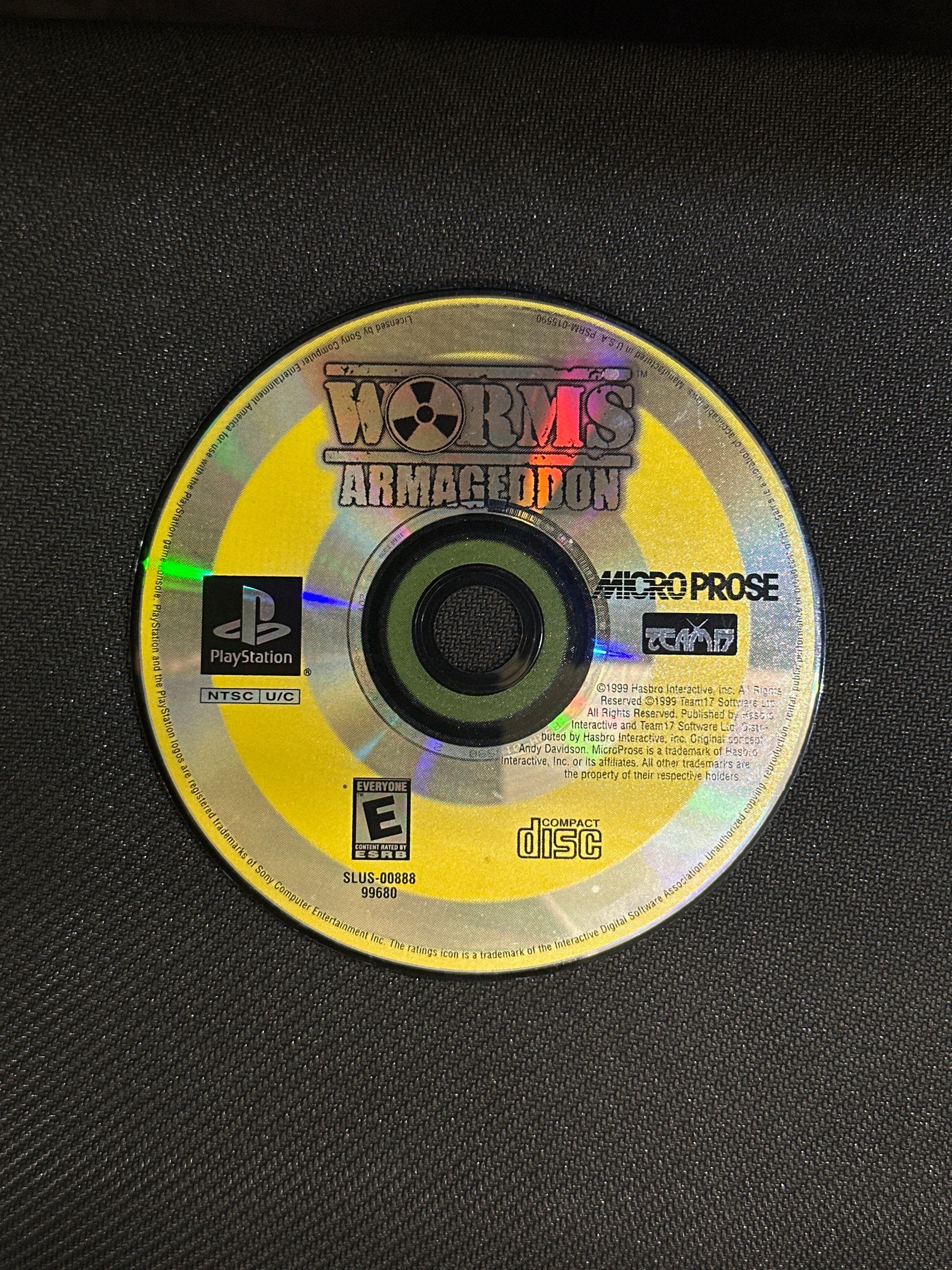 PlayStation game disc with 'Worlds Apart' on a black background