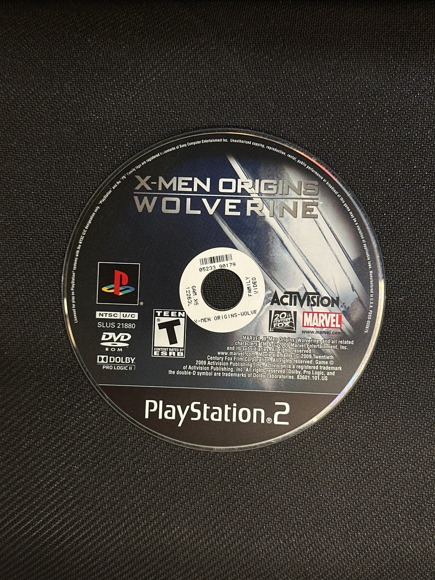 PlayStation 2 game disc for 'X-Men Origins: Wolverine' on a textured black surface