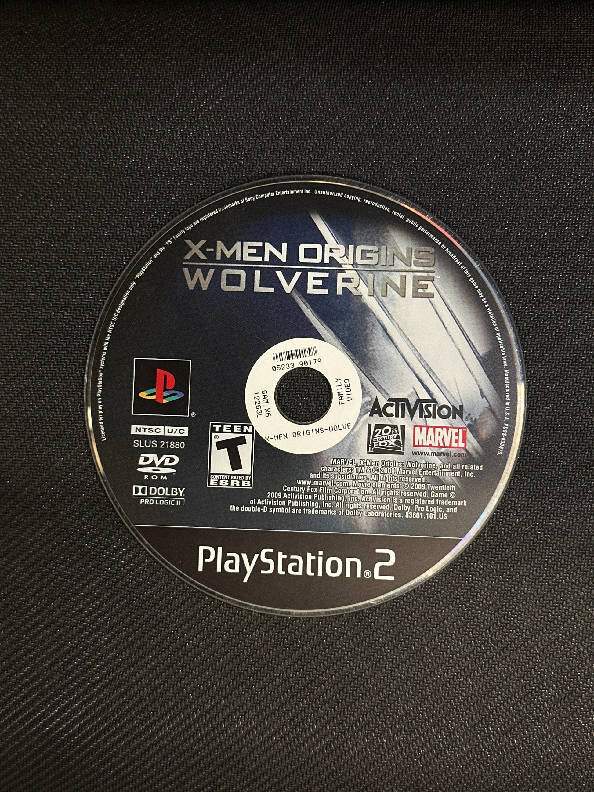 PlayStation 2 game disc for 'X-Men Origins: Wolverine' on a textured black surface